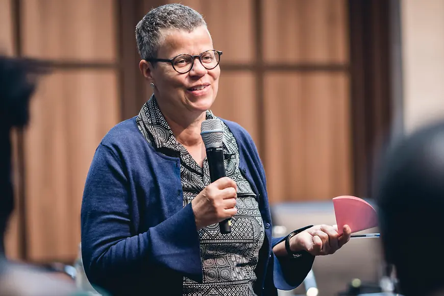 Teilnehmerin der Veranstaltung spricht ins Mikrofon