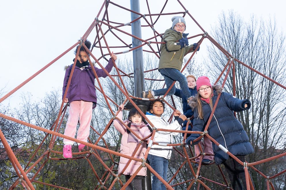 Das Bild zeigt mehrere Kinder in einem Klettergerüst